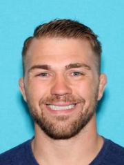 Bryan Caraway posing for a drivers license photo at Department of Licensing